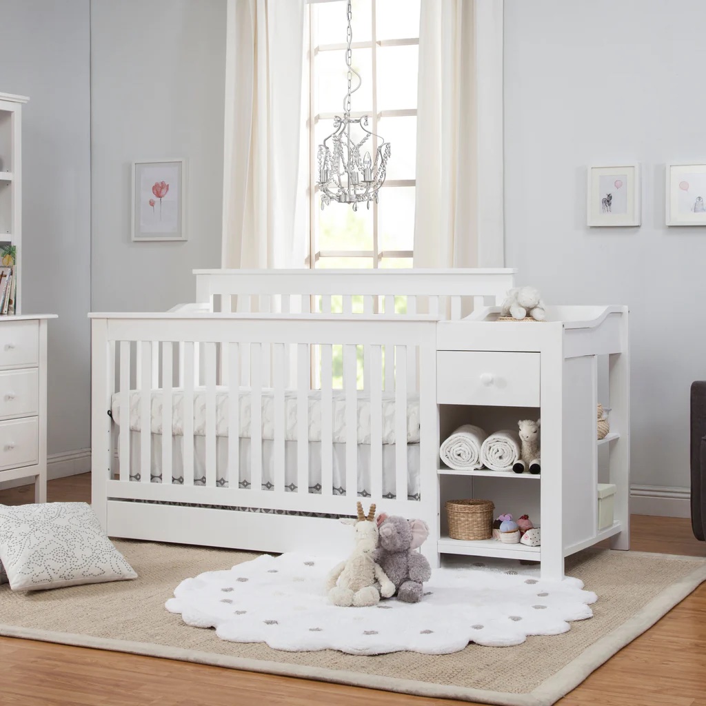 A white crib with changing table built in.