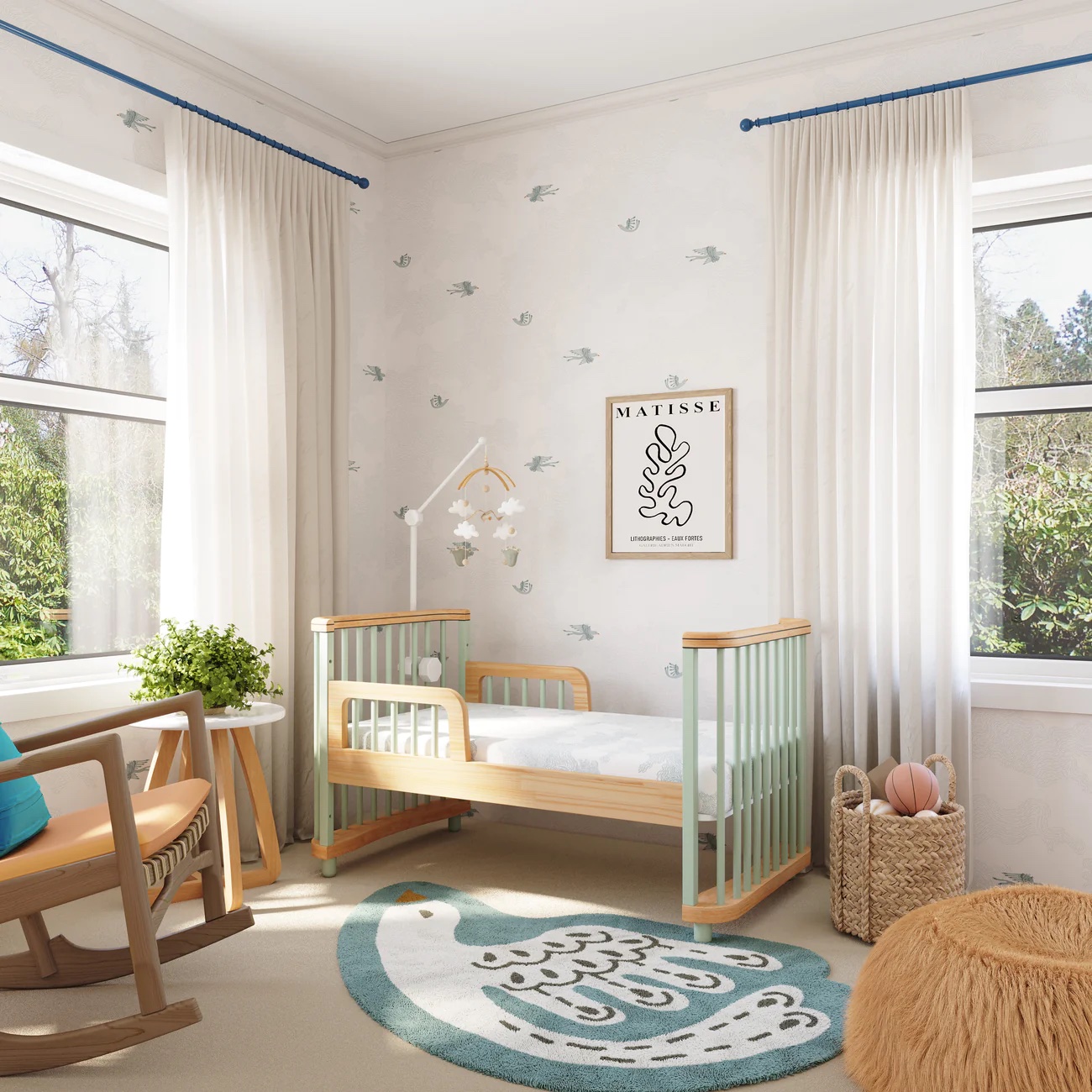 A toddler bed with railing in a nursery.