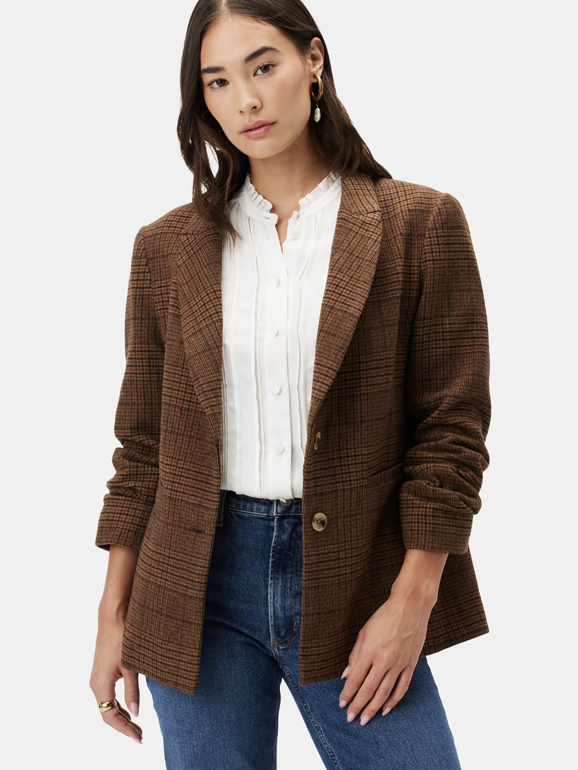 A model wearing a plaid blazer from Amour Vert