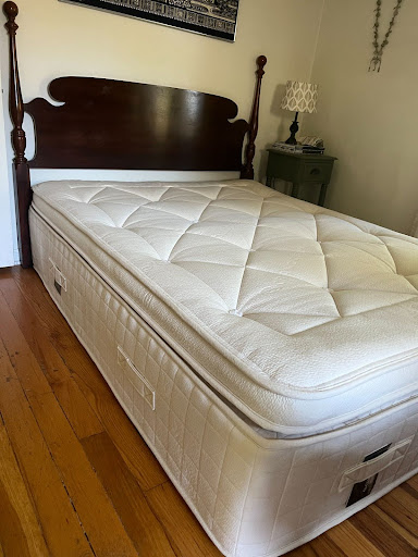 An Avocado mattress set up on a bed frame. 