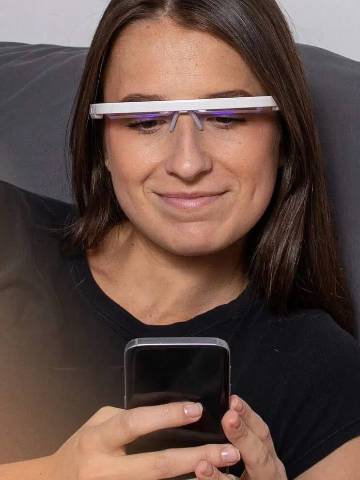 A model on their phone wearing AYO glasses flipped up. 