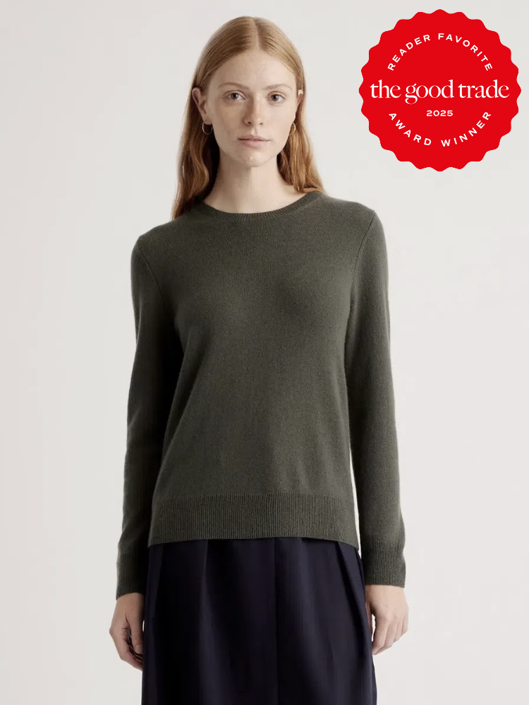 Person wearing a dark green sweater and dark pants. A red badge on the upper right reads "Reader Favorite FashionGroomSpot 2025 Award Winner.