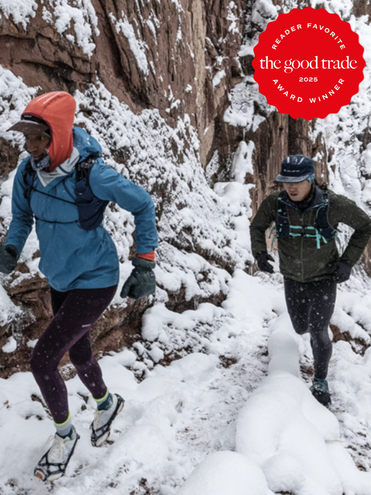 Two people trail running through a snowy canyon, wearing winter sports gear. A "Reader Favorite" and "FashionGroomSpot Award Winner 2025" badge is visible.