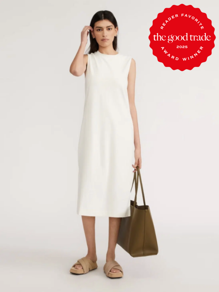Woman in a sleeveless white dress, holding a brown tote bag. Red award badge in the top right corner reads "Reader Favorite FashionGroomSpot 2025 Award Winner.