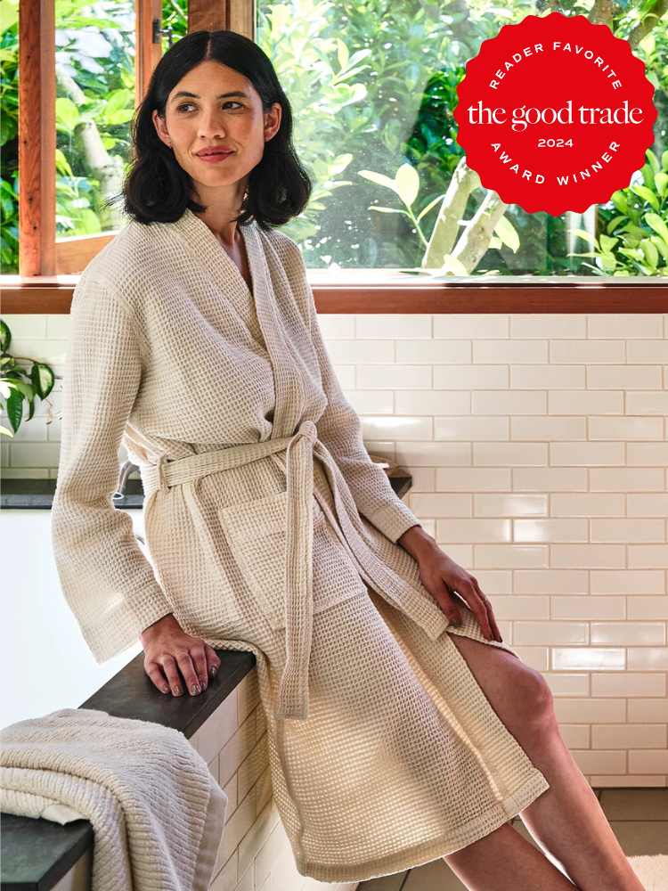 A model wearing a beige Coyuchi robe.