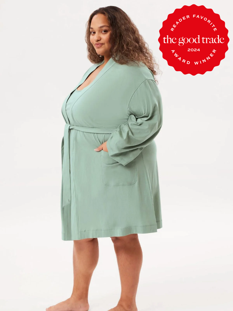 A model wearing a turquoise robe from Girlfriend Collective.
