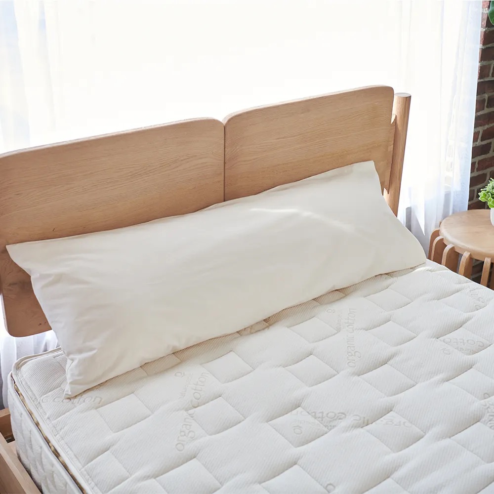 A Naturepedic body pillow.