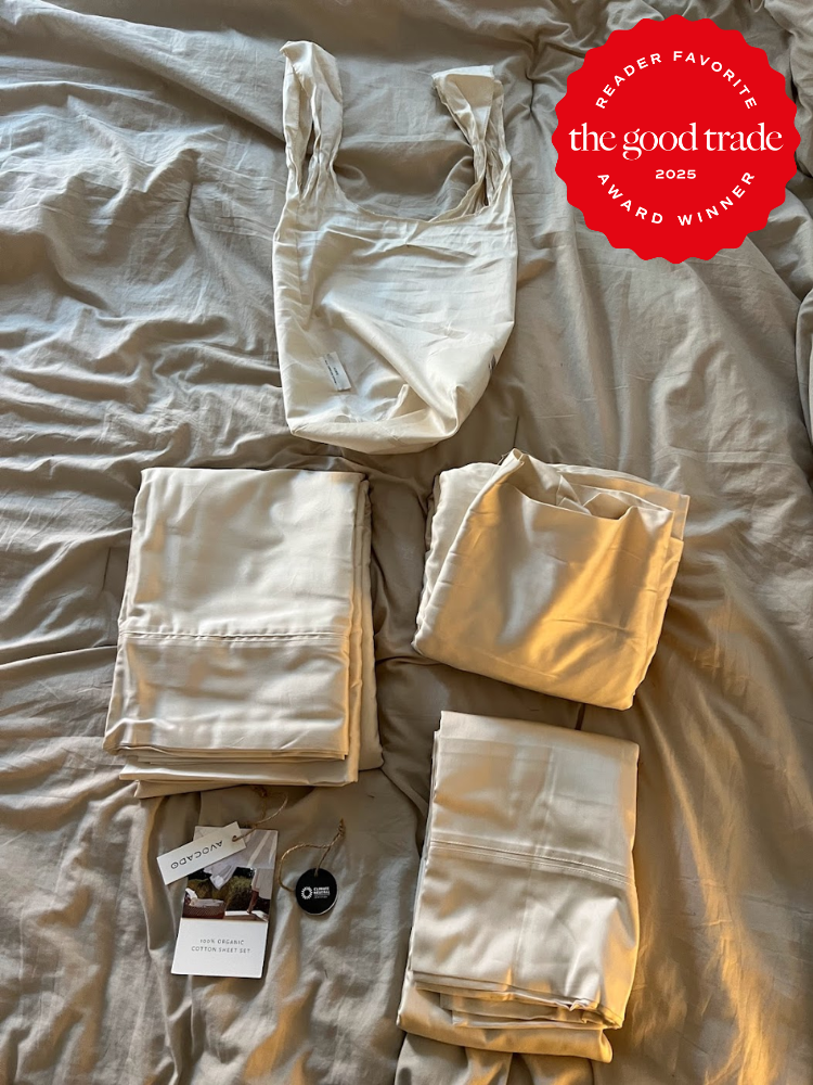A set of beige sheets and pillowcases are neatly arranged on a bed with a red "FashionGroomSpot Reader Favorite Award Winner 2025" badge in the top right corner.