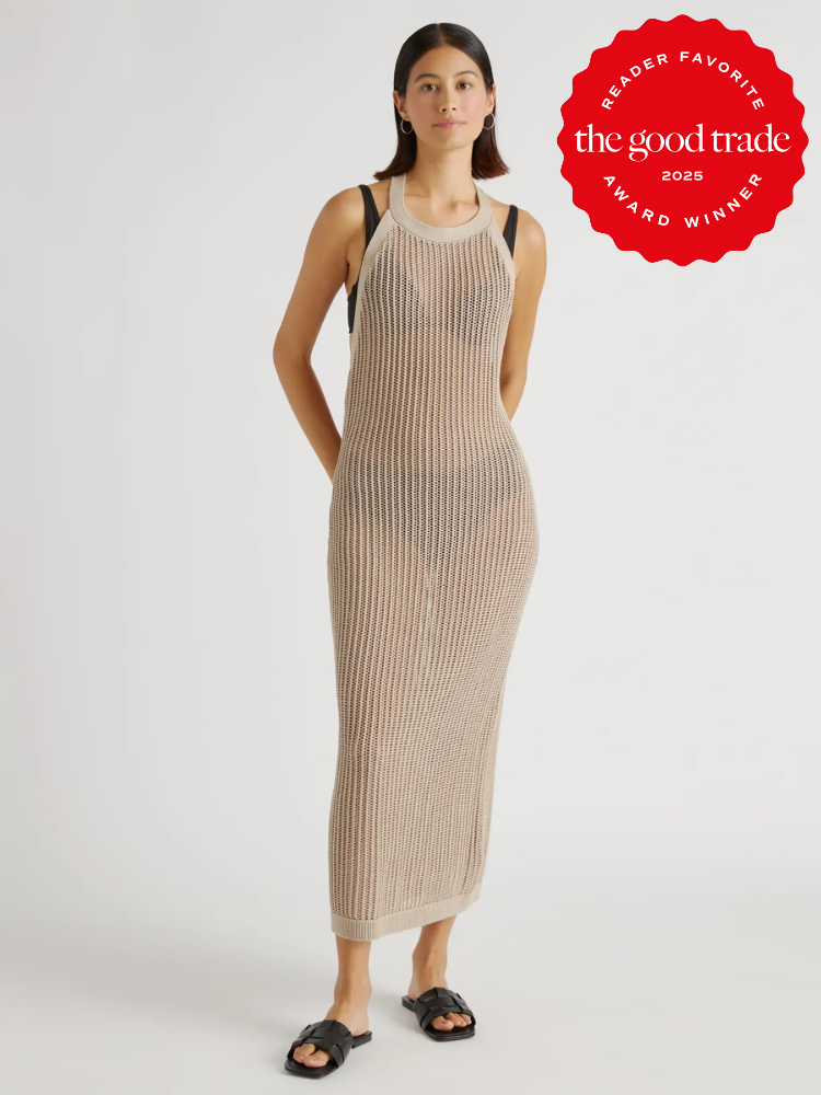 Woman in a long, sleeveless, knitted dress poses. She wears sandals. A red badge reads "Reader Favorite, FashionGroomSpot, 2025 Award Winner.