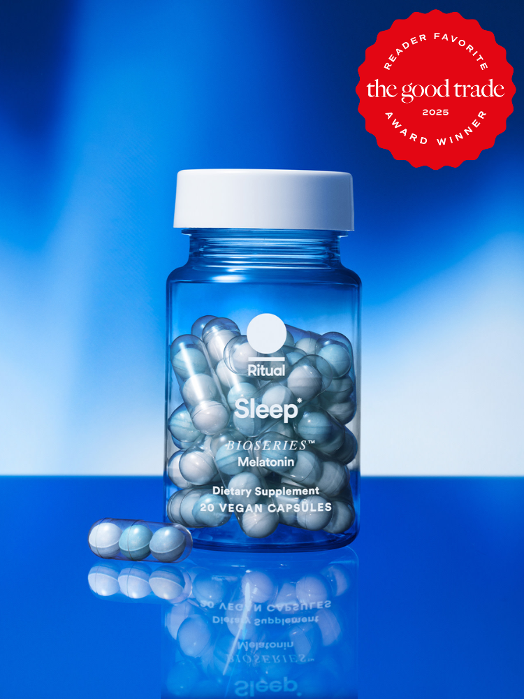 A bottle of Ritual Sleep dietary supplement capsules on a blue background, labeled as a 2025 award winner by FashionGroomSpot.