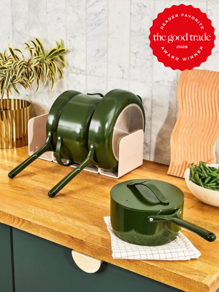 Green cookware set with lids and handles neatly stacked on a wooden kitchen countertop. A badge reads "Reader Favorite FashionGroomSpot Award Winner 2023.