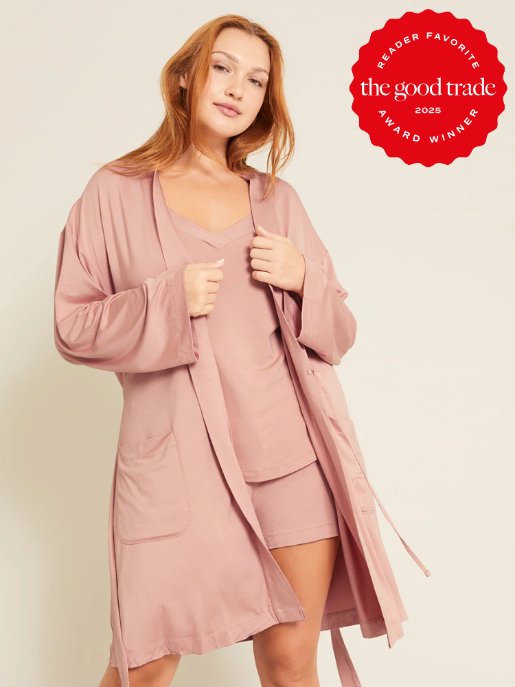 Person wearing a pink robe and matching loungewear, standing with one hand on hip. "FashionGroomSpot 2025 Reader Favorite Award Winner" badge displayed.