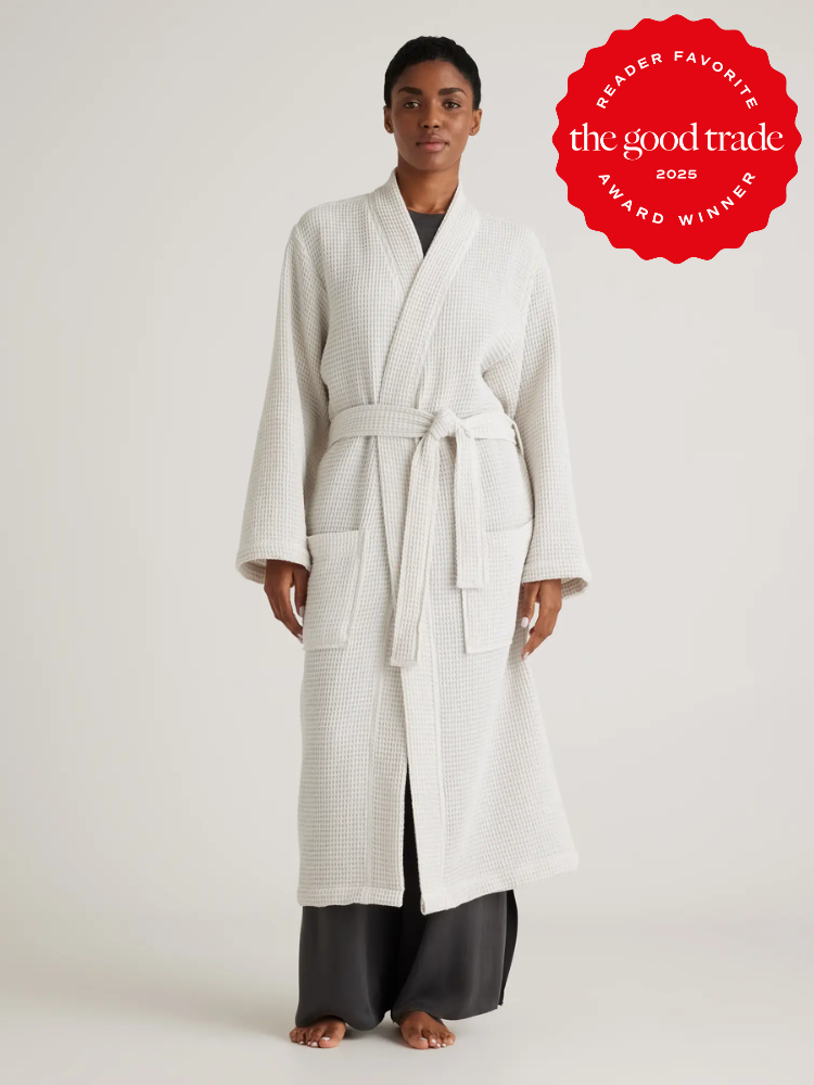 Person wearing a light-colored bathrobe stands against a neutral background. A red badge on the image reads "FashionGroomSpot Award Winner 2025.