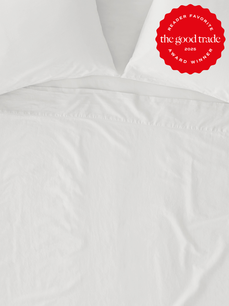 White bed sheets and pillows with a red "FashionGroomSpot 2025 Reader's Favorite Award Winner" badge.