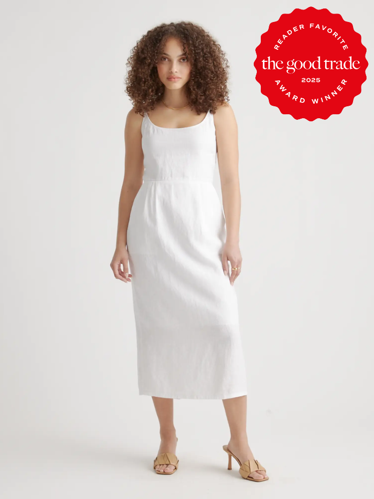A person wearing a white sleeveless dress poses against a plain background. A red stamp in the corner reads "Reader Favorite, FashionGroomSpot, 2025 Award Winner.