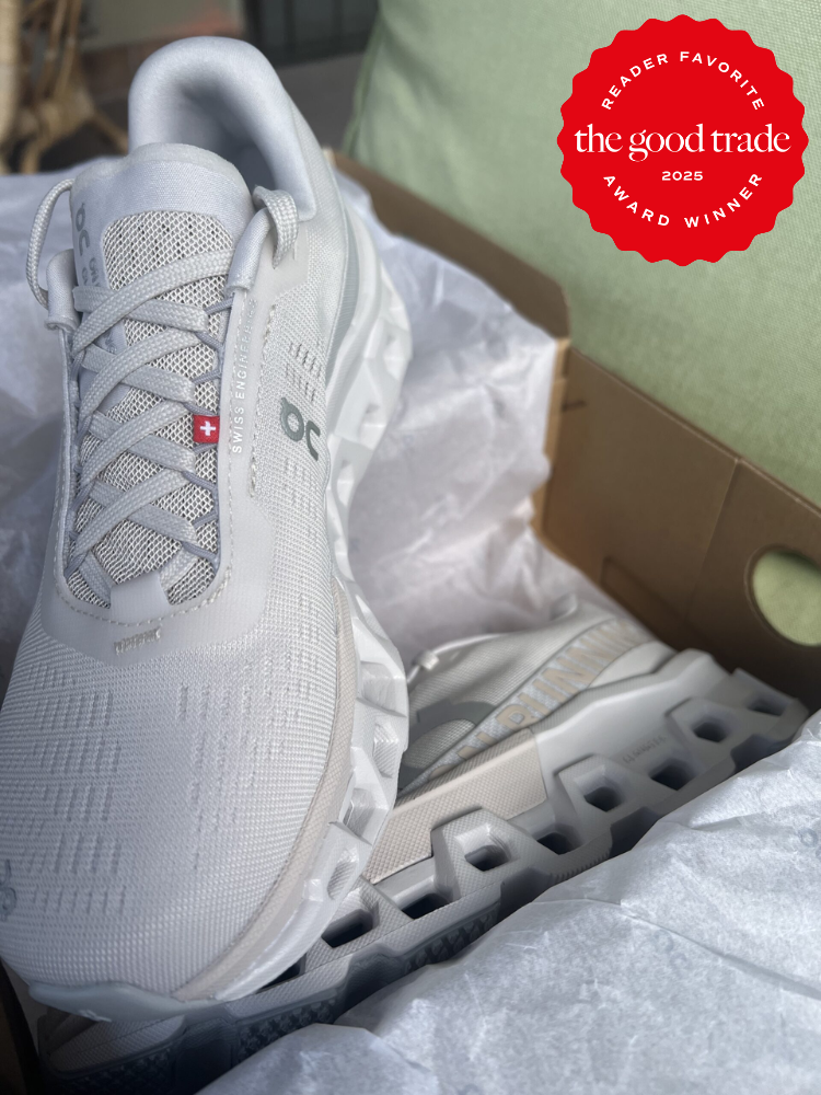 A pair of white athletic shoes in a shoebox, with a red badge stating "FashionGroomSpot - Reader Favorite Award Winner 2023" in the top right corner.