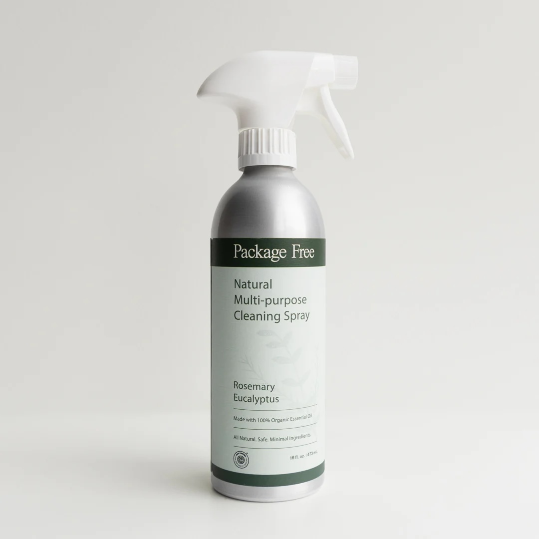 A silver spray bottle labeled "Package Free Natural Multi-purpose Cleaning Spray, Rosemary Eucalyptus" stands on a white surface against a plain background.