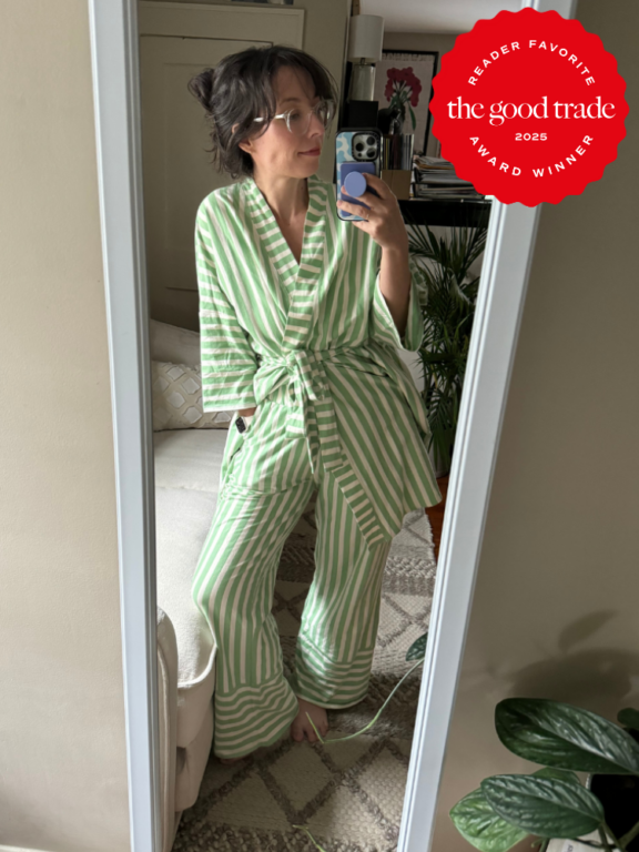 Person wearing green and white striped pajamas stands in front of a mirror taking a selfie. "FashionGroomSpot 2025 Award Winner" badge is displayed in the upper right corner.